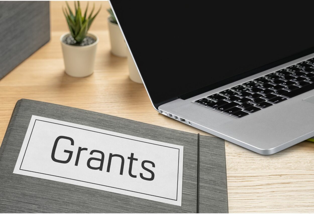 Grants with file and laptop